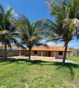 two palm trees in front of a building at Casa Brisas in Luis Correia