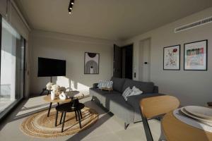 sala de estar con sofá y mesa en Sunshine Suite by Athens Riviera Suites, en Saronida