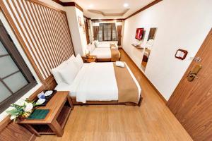 Postel nebo postele na pokoji v ubytování Khai Ngoc Hotel Da Lat City