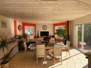 a dining room with a table and chairs at VILLA des CHEMINS in Cussac-sur-Loire