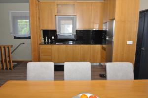 a kitchen with a table and chairs and a refrigerator at A3J Country House Lagares in Penafiel +12 photos