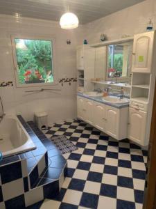a bathroom with a black and white checkered floor at VILLA des CHEMINS in Cussac-sur-Loire