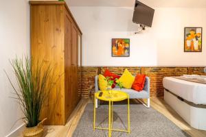 een woonkamer met een bank en een gele tafel bij El Rastro Historic center in Madrid