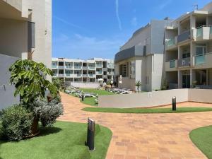 a courtyard of a apartment building with a resort at Paradise Palms I Deluxe, incl. Welcome Package in Corralejo