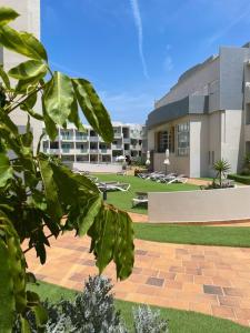 a building with a brick walkway in front of a building at Paradise Palms I Deluxe, incl. Welcome Package in Corralejo