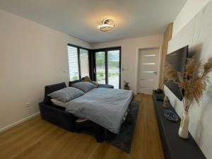 ein Schlafzimmer mit einem Bett und einem großen Fenster in der Unterkunft Apartmán 1.C in Šajdíkove Humence