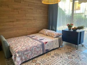 a bedroom with a bed and a table and a window at Villa Lavanda Golf in Balchik