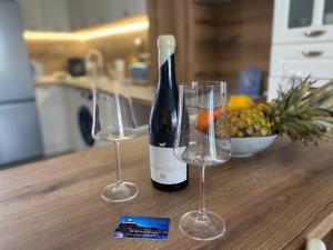 a bottle of wine and two wine glasses on a table at Villa Lavanda Golf in Balchik