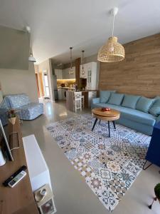 a living room with a blue couch and a table at Villa Lavanda Golf in Balchik