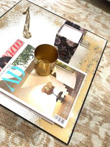 a magazine with a cup on top of a table at Chic Apartments Barcelona- Free Parking-10 min by metro from BCN Center in Barcelona