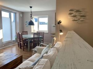 a living room with a couch and a table at Ferienwohnung-Seepferdchen-Finnlandring in Timmendorfer Strand