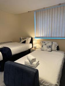 a bedroom with two beds and a window at City Stay in Colchester