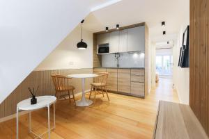 a kitchen and living room with a table and chairs at Sao Bento Classic by Homing in Lisbon