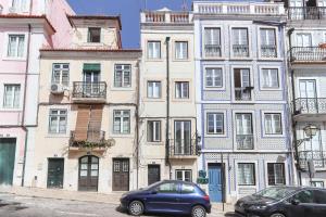 a blue car parked in front of a building at Sao Bento Classic by Homing in Lisbon