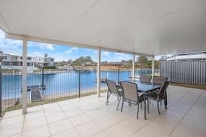 a dining room with a view of the water at Hibbard 12 in Port Macquarie