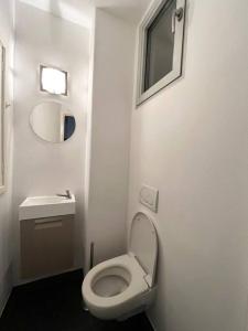 a small bathroom with a toilet and a sink at Amazing flat-Center of Brussels in Brussels