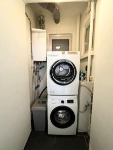 a washer and dryer in a small room at Amazing flat-Center of Brussels in Brussels