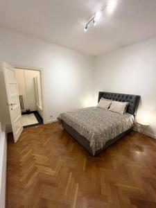 a bedroom with a bed and a wooden floor at Amazing flat-Center of Brussels in Brussels