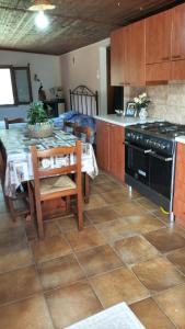 a kitchen with a table and a stove top oven at Il Giardino di Giò in Iglesias