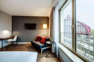 a hotel room with a bed and a window at NH Collection Antwerp Centre in Antwerp