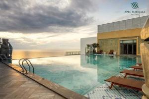 a swimming pool with a view of the ocean at Wins House - Apec Mandala Phú Yên in Tuy Hoa