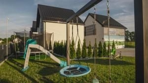 a playground with a slide in the grass at Słoneczne Zacisze Las obok Zatora in Las +64 photos