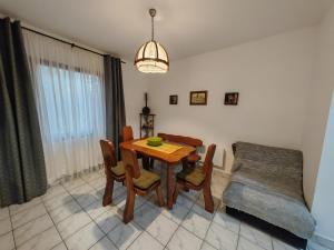 a dining room with a wooden table and chairs at Apartmani Todorovic in Vinci