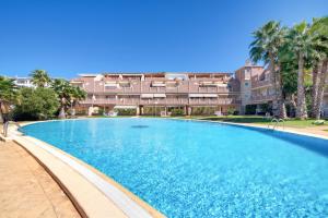 a large swimming pool in front of a building at Ca Blanca Paraíso ll in Denia