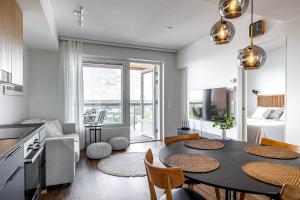 a kitchen and living room with a table and chairs at Tower Cabin in Tampere