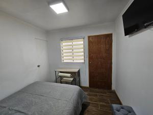 Tempat tidur dalam kamar di Guest House Club Hípico