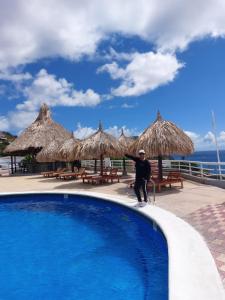 a man riding a skateboard next to a swimming pool at Hippocampus Vacation Club in Pampatar