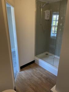 a bathroom with a shower and a tub and a toilet at The Seven Stars in Durham