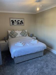 a bedroom with a large bed with two pillows at The Seven Stars in Durham +9 photos