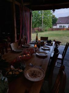 a long wooden table with plates of food on it at Camp Warmia in Stare Kawkowo