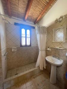 a bathroom with a shower and a sink at El Ensueño in Tilcara