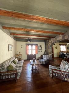 a large living room with couches and a stone fireplace at El Ensueño in Tilcara