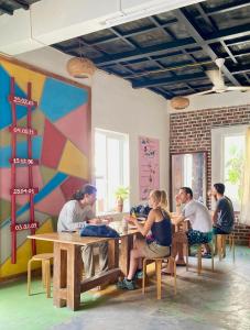 a group of people sitting at a table in a room at Domik Homestay - Cát Bà in Cat Ba