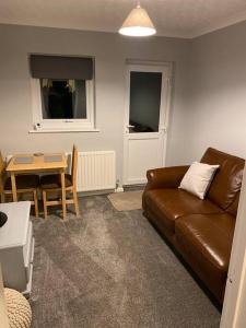 a living room with a couch and a table at Cosy 1 Bed Home @Stevenage in Shephall