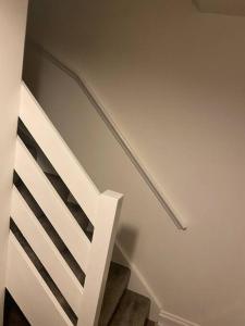 a stairway with a white railing and a stair case at Cosy 1 Bed Home @Stevenage in Shephall +2 photos