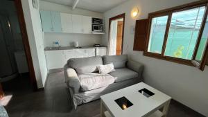 a living room with a couch and a table at Cosy Country Studio near Maspalomas and Fataga in Artedara