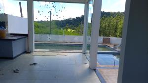 an open door to a swimming pool in a house at Casa de campo in Natividade da Serra +9 photos