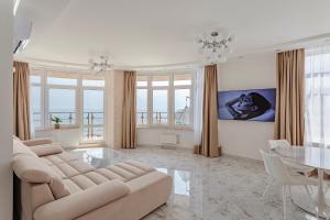 a living room with a couch and a table at Direct sea view in Odesa