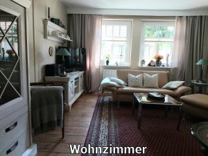 a living room with a couch and a table at Alte Schule Mankmuß in Karstädt