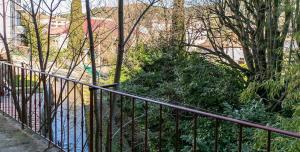 a metal fence next to a body of water at Le Coeur Ardéchois in Vals-les-Bains +1 photo