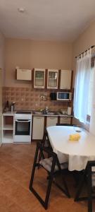 a kitchen with a table and a white table and chairs at BudaWestHouse in Budakeszi