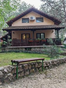 a house with a bench in front of it at Apartmani Todorovic in Vinci