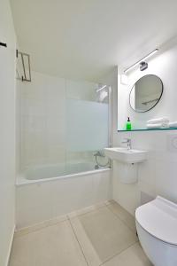 La salle de bains est pourvue d'une baignoire, d'un lavabo et de toilettes. dans l'établissement Les Chevaliers des Balances, à Saint-Aubin