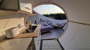 an internal view of a tiny house with a round window at Ecolieu BnBubble Drincham by BubbleTree BBT SARL in Drincham