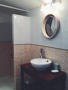 uma casa de banho com um lavatório e um espelho em Loft atypique pour 2 personnes em Nieulle-sur-Seudre