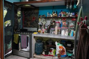 a cluttered kitchen with a cluttered counter top at Blue Butterfly House in Pavones